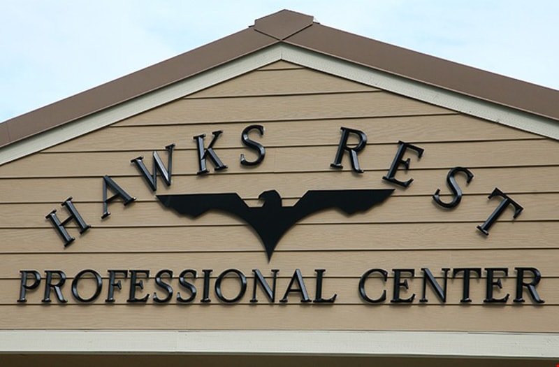 painted black injection molded letters in architectural font beveled face outside professional corporate building