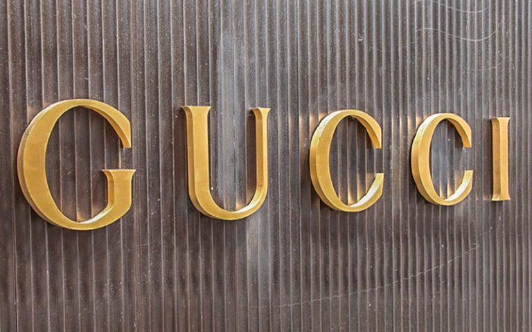 Gold Anodized Aluminum Letters mounted on corrugated siding for gucci retail store