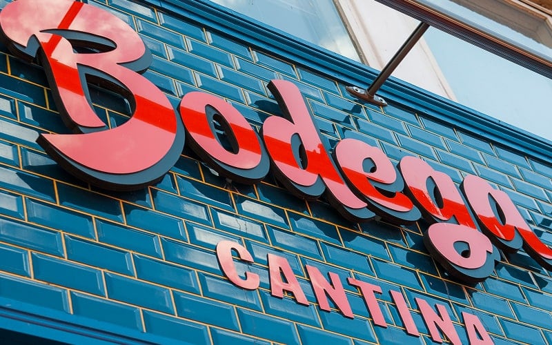 layered acrylic letters signs in glossy red and black acrylic for cantina restaurant outside on tile