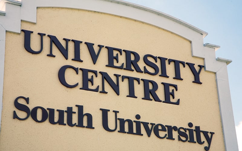 large black exterior letters on tan monument