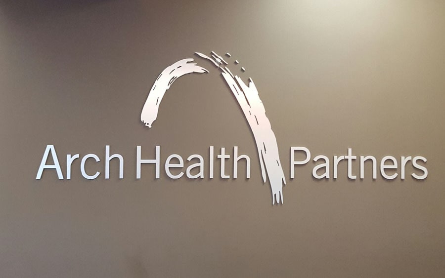 custom metal sign brushed stainless on brown interior wall